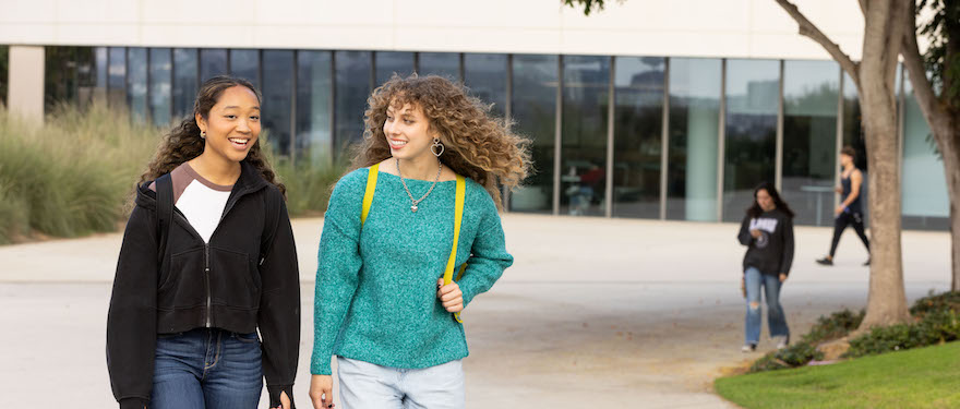 Two female walking together and talking